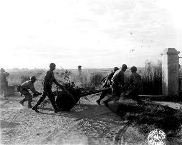 SC 364506 - 37mm gun being placed on road to Megalang, Luzon, P.I.