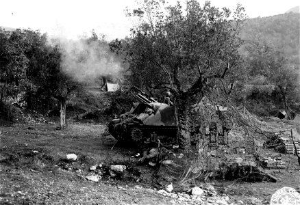 SC 329834 - M7 105mm self-propelled howitzer of A Battery, 91st F.A. Bn., armored artillery, firing. 30 December, 1943.