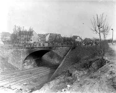 SC 270682 - 5th Division infantry of the 3rd U.S. Army march over bridge in Castellaun, Germany, to clear forests left by the 4th Armored Division, south of Reisweiler. 18 March, 1945. photo