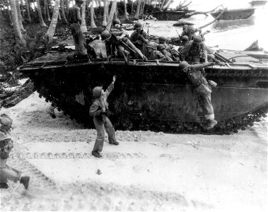 Quickly disembarking from tractor attacking inland. Guadalcanal. 10 March, 1944.