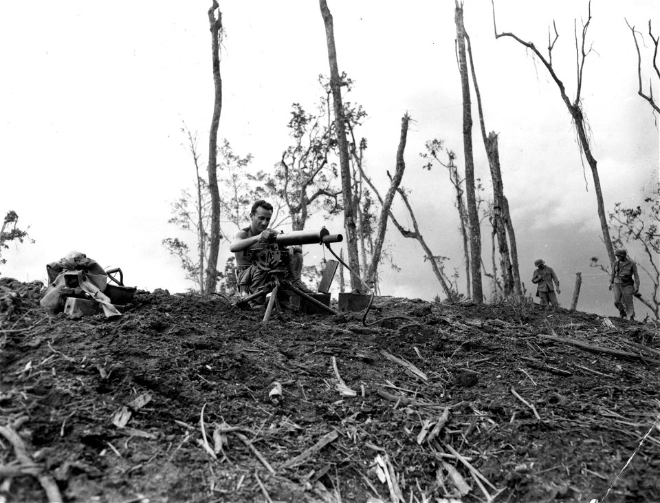 SC 364573 - Few minutes after bloody Hill 60 was taken, an Americal machine gunner quickly sets up a position on the battered side of the hill formerly held by the Japs.