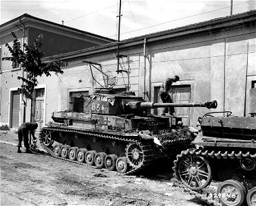 SC 329848 - U.S. troops inspect abandoned German Mark IV tank. Ponsacco area, Italy. 18 July, 1944.