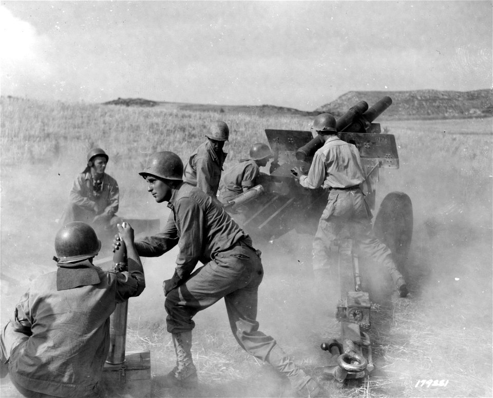 SC 179881 - Cpl. Alfred Kranstaky, Plainfield, N.Y., and Pvt. Charles Ludington, fire 105mm howitzer at enemy. Sicily. 14 August, 1943.