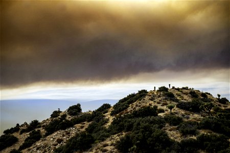 Smoke from the Apple Fire over desert hills