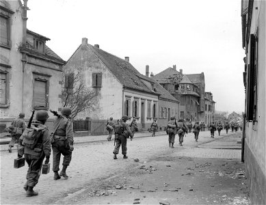 SC 270632 - Infantrymen moving through the town of Zweibrucken, Germany. 20 March, 1945. photo