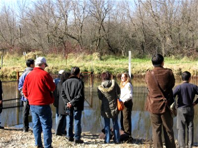 Biologist Wendy Woyczik with chinese delegation at invasive carp control barrier