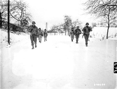 SC 270677 - These men are part of the 2nd Infantry Regiment, 5th Infantry Division, that was pinned down for a day and a half before American tanks reached and relieved them near Diekirch, Luxembourg.