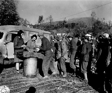ARC workers distribute coffee and doughnuts to 91st Div. replacements near the Fifth Army front.