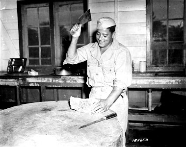 SC 184650 - A good dinner is in store for a company of an Air Base Security Bn. in the South Pacific Area, judging by the smile of Sgt. Walter Rothschild. photo
