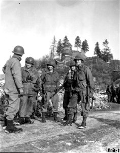 SC 335400 - Soldiers of the U.S. First Army greet patrol of U.S. Third Army in the front-lines town of La Roche, Belgium, where men of the two American armies met for the first time on January 14th. photo