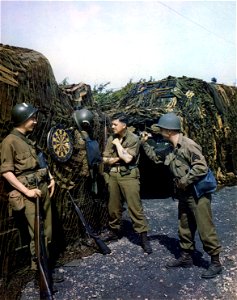 C-1123 - Combat soldiers while away time with a game of darts as they await the signal which will send them from England to Hitler's Europe for the big day. photo
