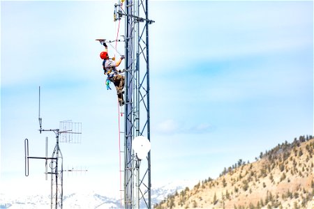 Dave Kelser, Electronics Technician, climbing a communications tower (2) photo