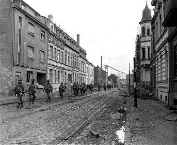 SC 336788 - Infantrymen of the 95th Division, 9th U.S. Army, move into the town of Uerdingen, Germany. 5 March, 1945. photo