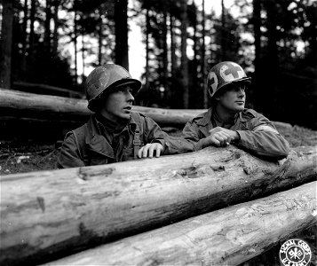 SC 196161 - The Century Div. arrived in the combat zone with the medics helmets prominently marked on all sides like the one worn by S/Sgt Roy G. Carlson, Pencer, Minn.