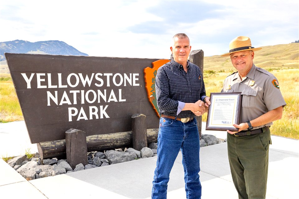 Congressman Rosendale presents Superintendent Cam Sholly a signed copy of the congressinal record honoring Yellowstone's 150th anniversary