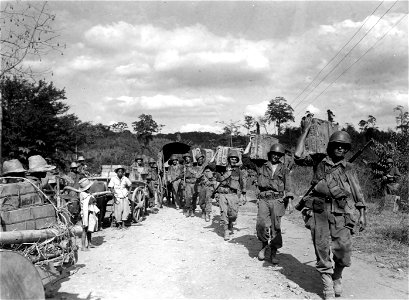 SC 396830 - Infantrymen carrying rations on their shoulders to the front lines. photo