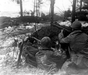 SC 364326 - 99th Division riflemen keep on the alert in their log-reinforced foxhole near Rocherath, Belgium.
