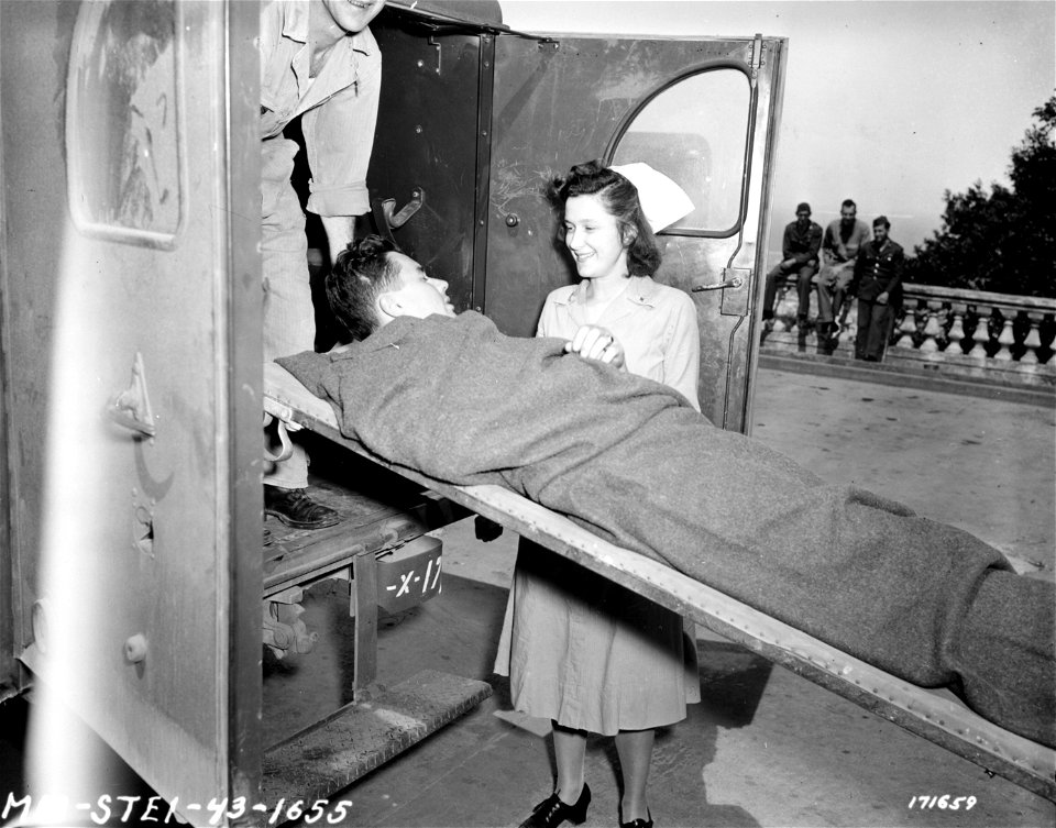 SC 171659 - An American Army Nurse receives patient at one of the hospitals in Algiers, North Africa. 1 May, 1943.