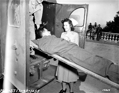 SC 171659 - An American Army Nurse receives patient at one of the hospitals in Algiers, North Africa. 1 May, 1943. photo
