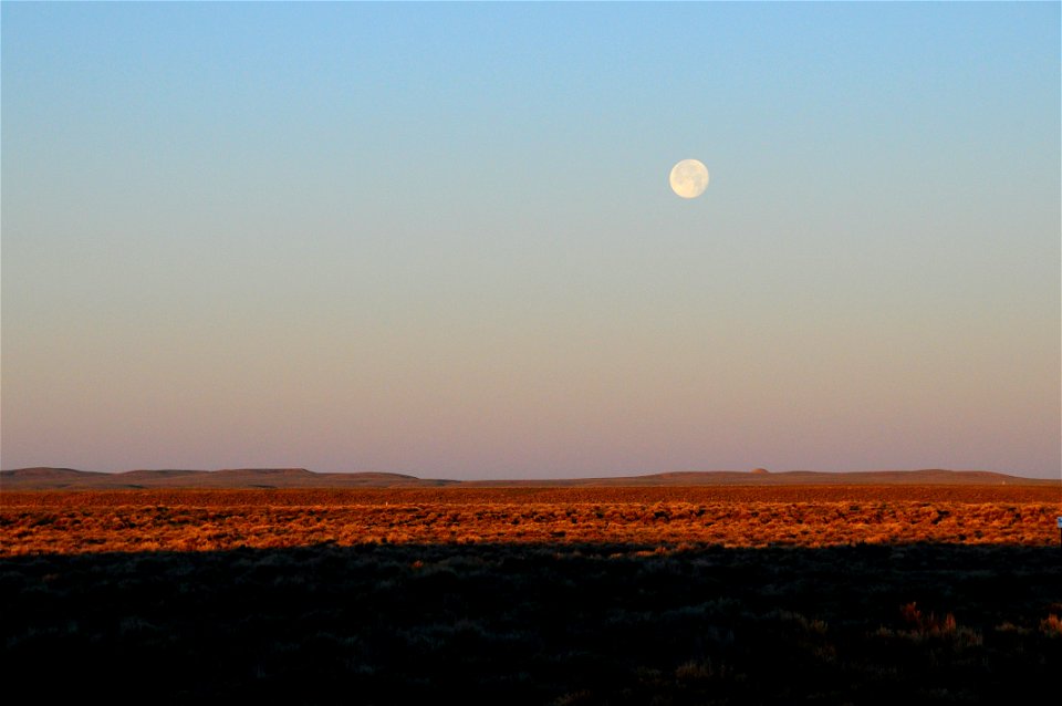 Strawberry moon setting over sage steppe at Seeskadee National Widlife Refuge Wyoming