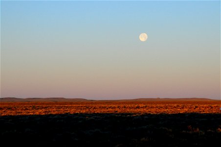 Strawberry moon setting over sage steppe at Seeskadee National Widlife Refuge Wyoming photo