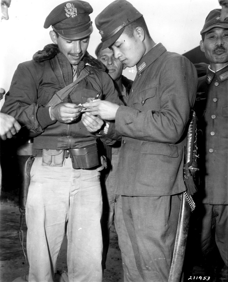 SC 211453 - A Japanese general signs a "short snorter" bill for Lt. Phillip Long of McAllen, Texas, co-pilot of the first two boats to land on Korea. 10 September, 1945.