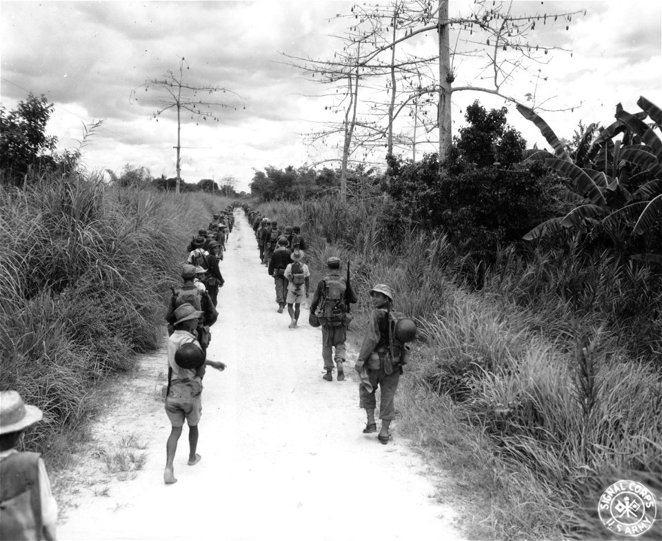 SC 270579 - Infantry troops marching towards the Mindanao River in pursuit of Japs retreating near the Fort Pikit Ferry, Mindanao Island. 22 April, 1945.