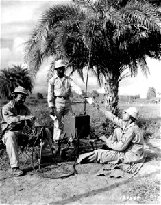 SC 164669 - A message is speeded on its way by these men from a Hq. Det. of an Air Base Security Bn. somewhere in the South Pacific Area. photo
