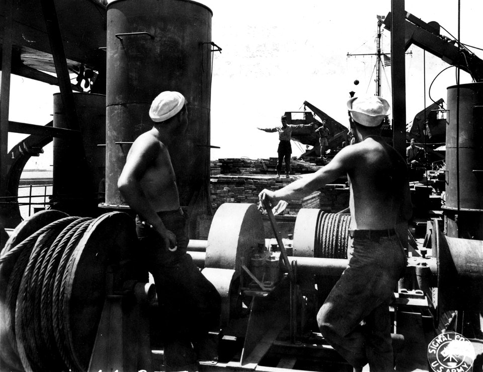 SC 364345 - A load of lumber that will be used for harbor reconstruction going down on the LST's elevator to waiting trucks below.