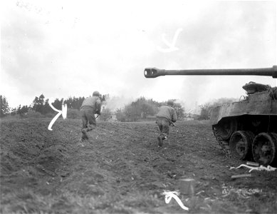 SC 270883 - A tank of the 11th Armored Division, 3rd U.S. Army, covers advancing infantrymen who close in on burning buildings in Neufelden, Austria. 4 May, 1945. photo