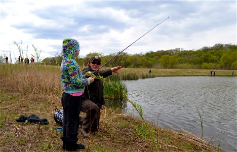MN Valley National Wildlife Refuge employee Mike Malling assists student in a casting lesson. photo