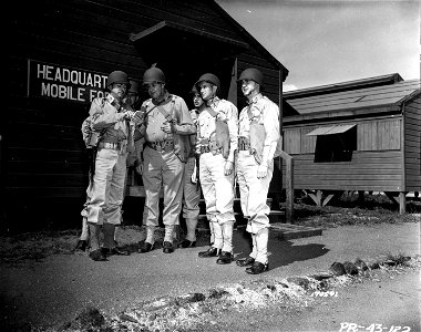 SC 170591 - General Nat S. Perrine, of Ft. Worth, Texas, Commanding General of the Mobile Force and his staff, receiving a report in front of headquarters. photo