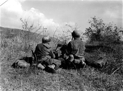 SC 364507 - Co. B, 63rd Inf. machine guns chatter as they cover the advance of B Co. attempting to capture section of Demortis-Posario, Luzon, P.I. road. 22 January, 1945.