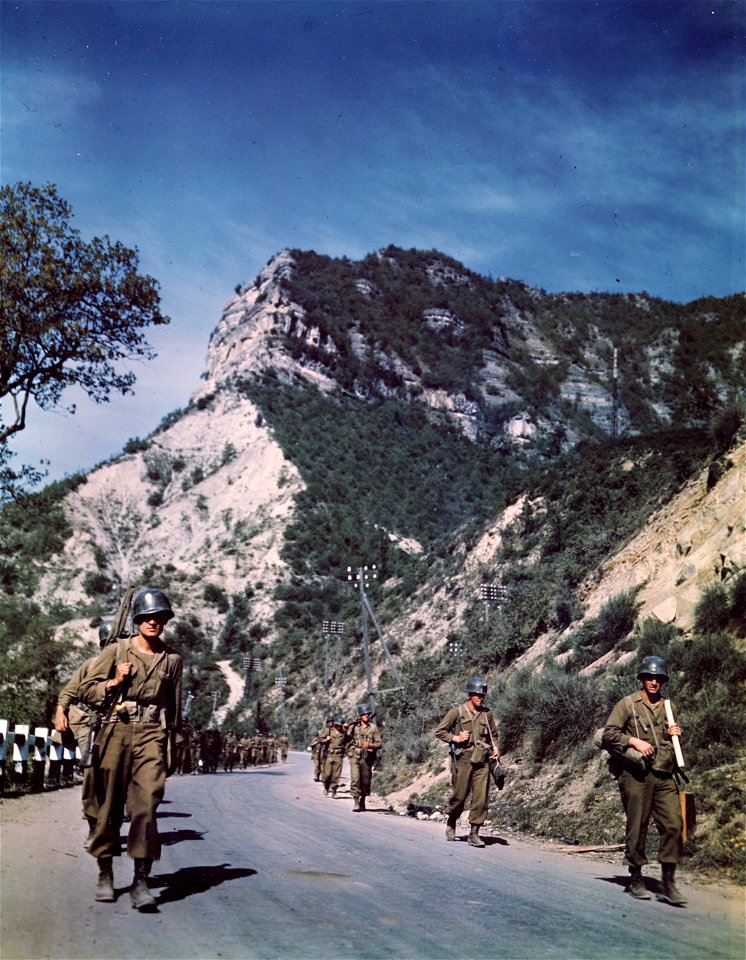 C-1122 - Infantrymen of the 88th Division march along picturesque mountain highway #64 leading to Bologna. Little resistance was encountered in this sector.