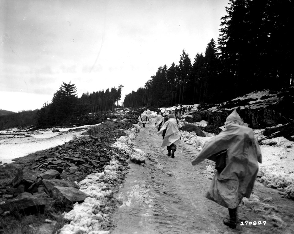 SC 270827 - Snow-caped infantrymen the 60th Inf. Regt., 9th Inf. Div., U.S. First Army, move towards Dedenborn, Germany, as Nazis retreat during heavy fighting on this sector. 2 February, 1945.