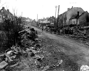 SC 329942 - Nazi motorized equipment reduced to scrap by incessant pounding of air and ground units on retreating German column is shown in the above photo after being shoved aside by bulldozers in the town of Gagnies-Chausser, Belgium.