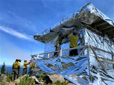 Waldo Mountain Lookout being wrapped for fire protection during 2022 Cedar Creek Fire on the Willamette National Forest on August 5, 2022.