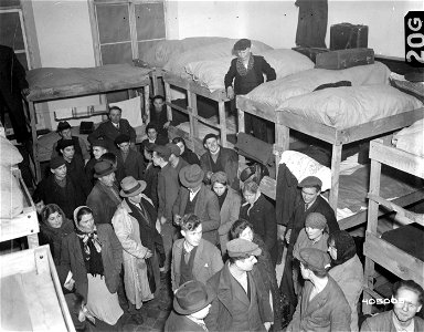 SC 405005 - At a displaced persons center in a Belgian city, liberated Russians who had been enslaved by the Germans await assignment to beds in their new billet. 6 March, 1945.