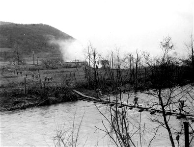 SC 270633 - Men of the 9th Infantry Division crossing the river on an infantry assault bridge put up by men from Co. "B", 51st Engineer Combat Battalion. photo