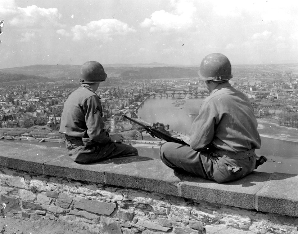 SC 335332 - Two U.S. infantrymen view the city of Koblenz from the top of the fort. 26 April, 1945.