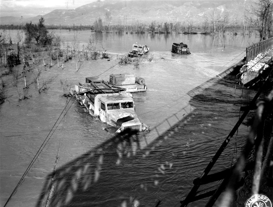 SC 329869 - Heavy trucks caught in the raging flood waters of the Volturno River when its waters rose approximately 12 feet in four hours. 5 December, 1943.