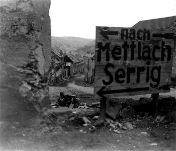 SC 364329 - A machine gunner of 94th Infantry Division, 3rd U.S. Army, is cleaning out snipers in Beurig, Germany. photo
