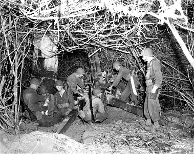 SC 166705 - The gun crew sets the gun in a well-camouflaged jungle position during a night problem over difficult terrain. Rockhampton, Australia. 1 December, 1942. photo