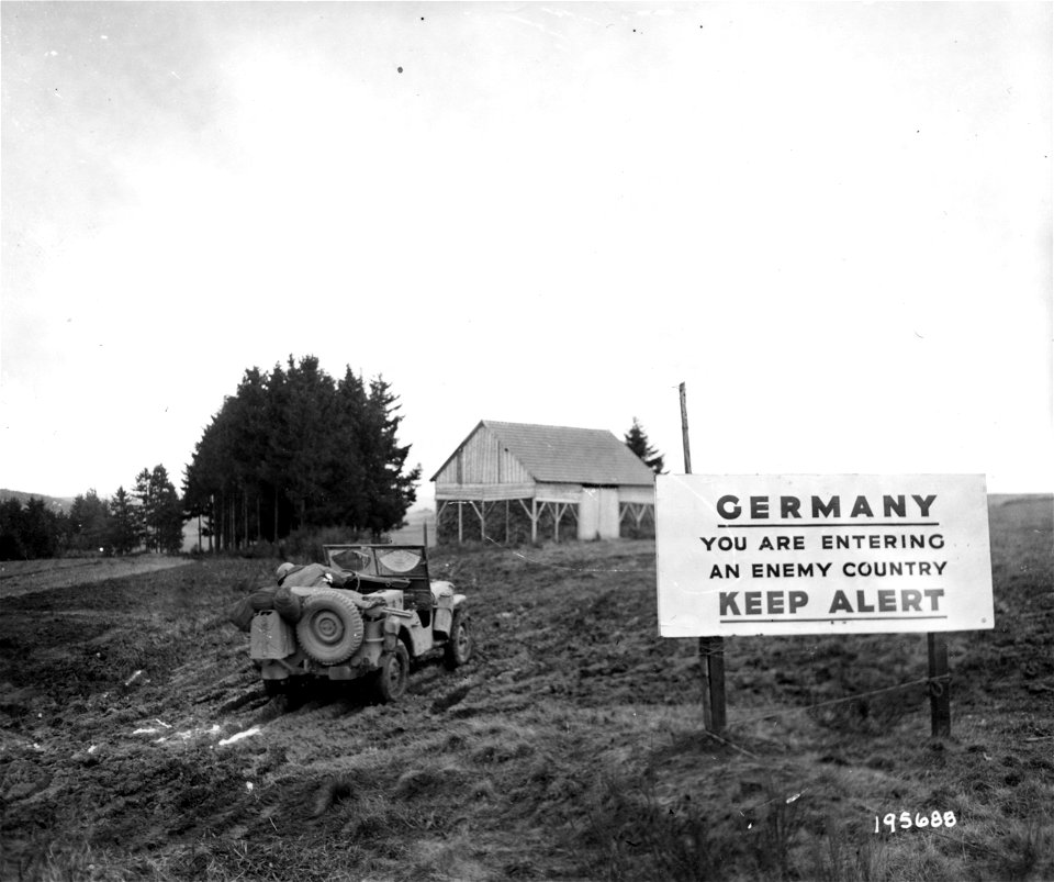 SC 195688 - This sign on a roadway leading into Germany serves as a warning to American infantrymen. 20 October, 1944.