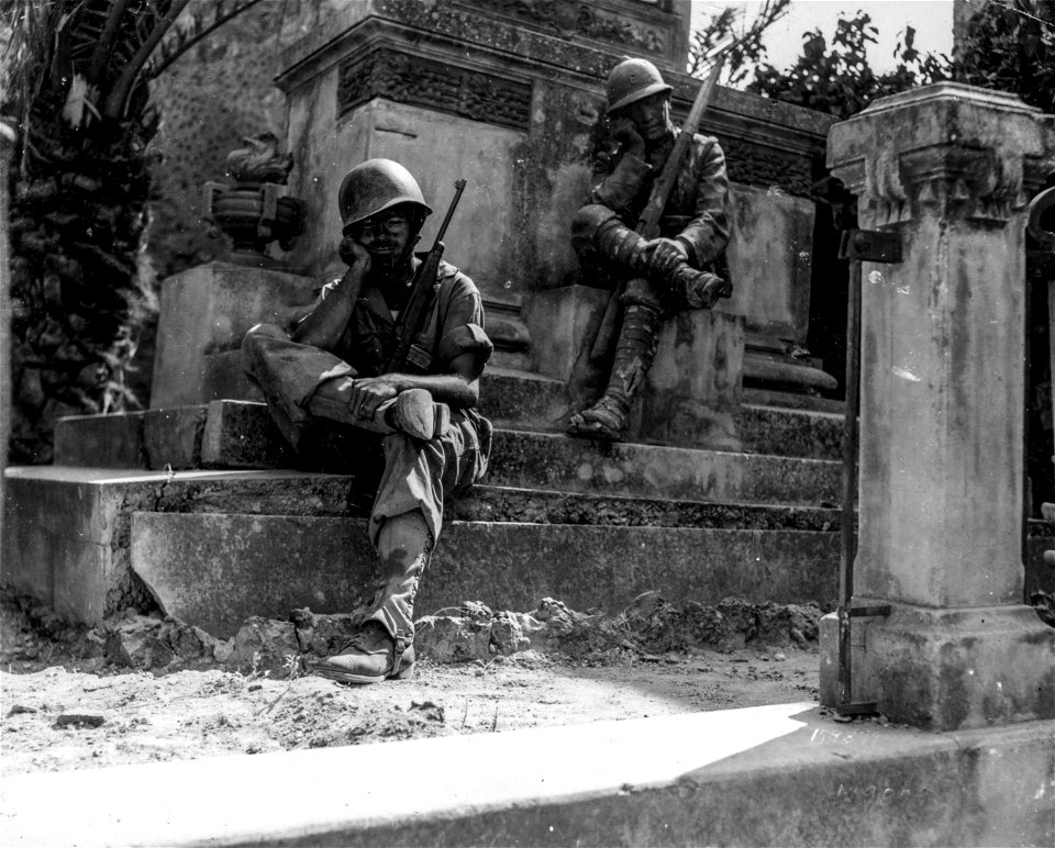 SC 179879 - Sgt. Norwood Dorman, Benson, N.C., stops to rest at at the memorial to the Italian soldier of World War I.  Brolo, Sicily. 14 August, 1943.