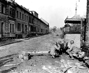 SC 334964 - Anti-tank gunners set up their 57mm gun, commanding a street in the outskirts of Kleinblittersdorf, alert for a possible counterattack by the enemy. photo