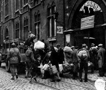 SC 195523 - Polish civilians, formerly used as slave labor by the Nazis in Belgium, get aboard a truck at the St. Clair Displacement Center at Narviers, Belgium, which will take them to a camp where they will receive food, shelter, clothing... photo