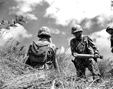 SC 151491- Pvt. Frank Rachew, displays one of the white phosphorus mortar smoke shells used during the problem for the designation of targets. Hawaii.