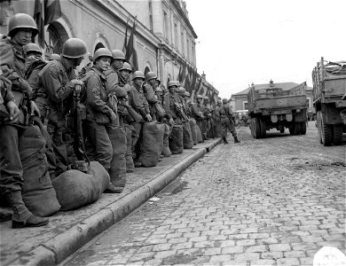 SC 271399 - Troops of the 44th Division await truck transportation after unloading at a station in Northern France. They are on their way to the front. photo