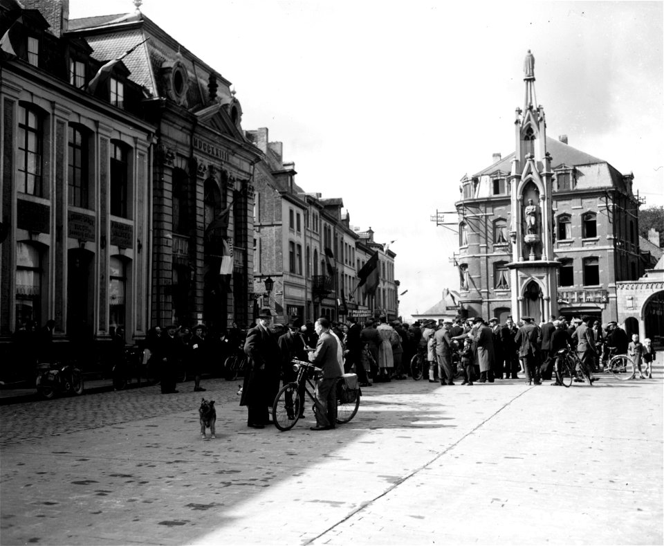 SC 329940 - Residents of Chimay, Belgium, gather in their town square to welcome their liberators, the first American troops to reach their town. 3 September, 1944.